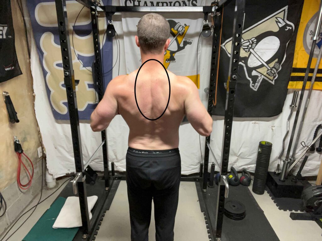 Person Posing by Flexing the Upper Back