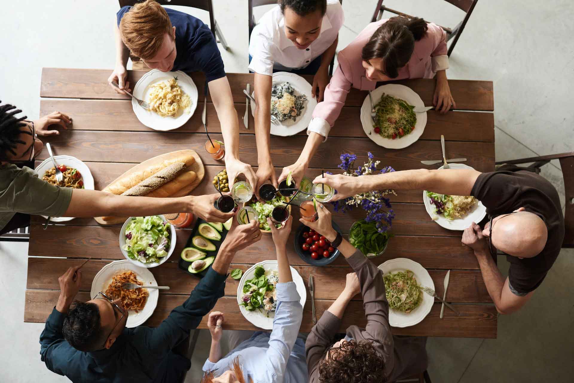 A group of people eating Thanksgiving dinner, How to Avoid Weight Gain Over Thanksgiving